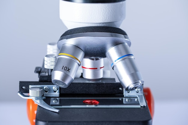 Blood sample on a glass slide under a microscope in the laboratory Blood test research