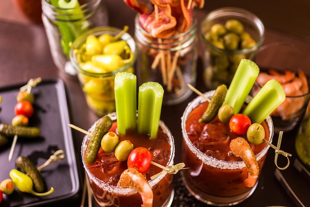 Bloody mary cocktail bar with variety of garnishes.