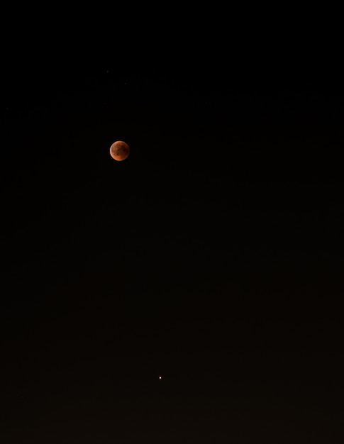 Bloody moon in the dark sky 2018. Crimson moon. Mars below