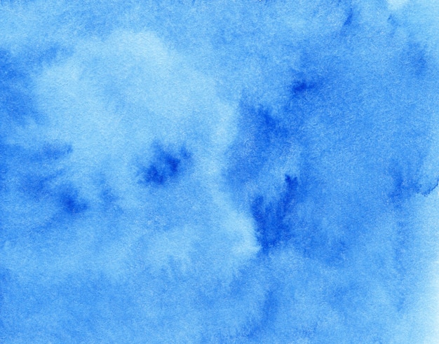 Blue abstract watercolor background on textured paper