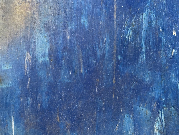 blue artistic paint on metal texture grunge wall surface aged rough abstract strokes backdrop