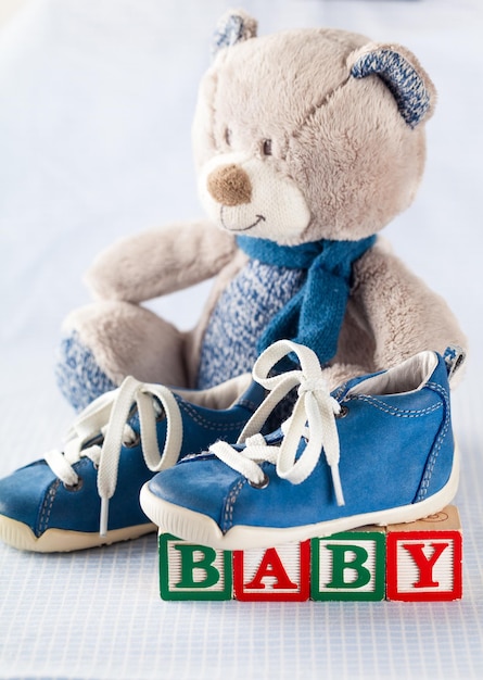 Blue baby shoes with toy