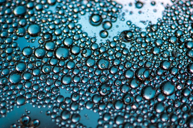 Blue background. Abstract macrophotography. Oil bubbles. Water texture.