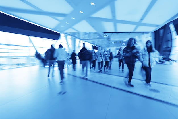 blue background blurred movement of people shopping mall