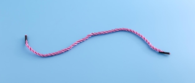 Blue background picture with a pastel pink rope