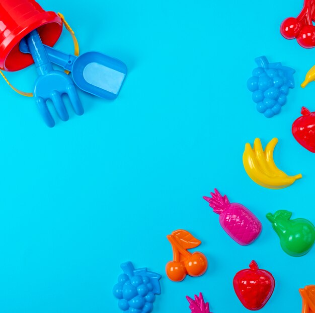 Blue background with childrens colorful toys 