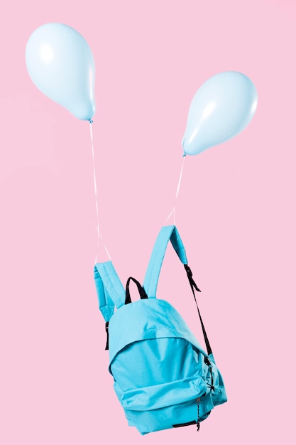 Blue backpack tied up with balloons