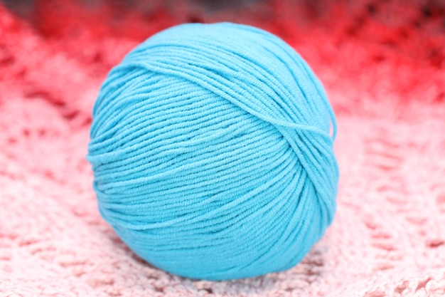 Blue ball of wool lies on a knitted napkin. High quality photo