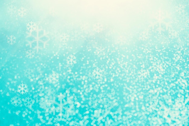 Blue bokeh background, snowflakes for christmas, defocused round lights and sunbeams, flare overlay