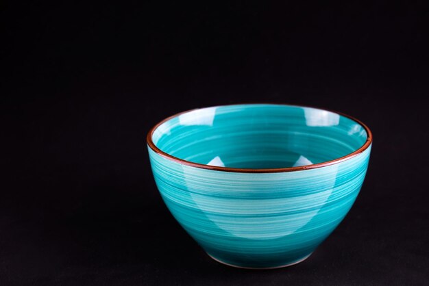 Blue bowl on a black background Copy space