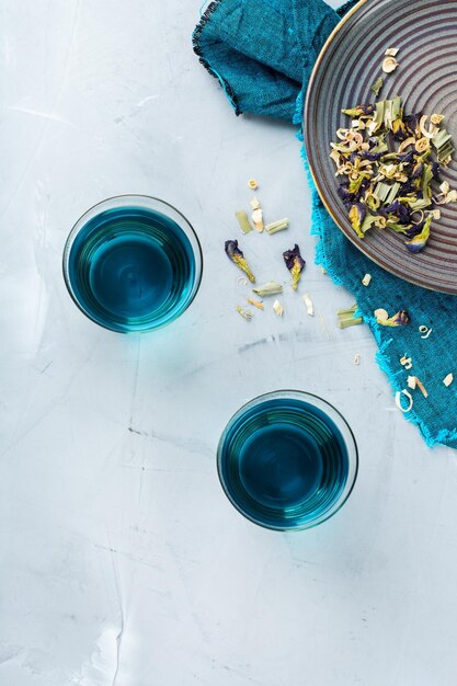 Blue butterfly pea flowers tea in a glass on table