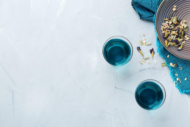 Blue butterfly pea flowers tea in a glass on table