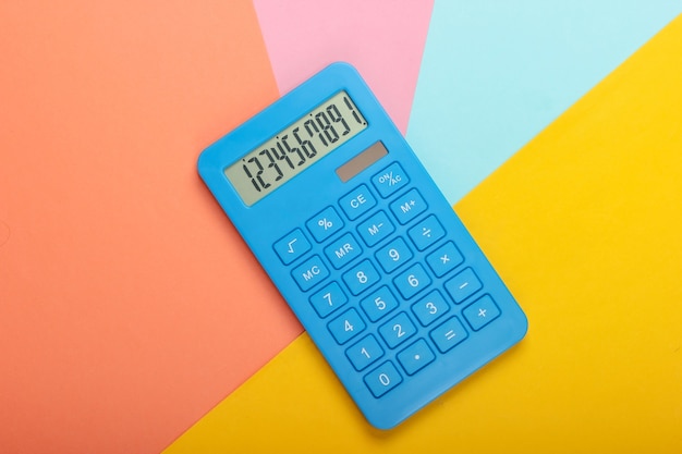 Blue calculator on colored pastel background. Calculation or counting. Minimalism. Top view