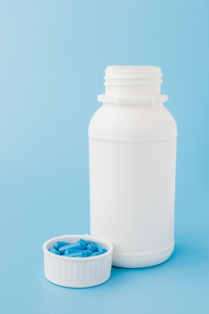 Photo blue capsules, pills on a blue background