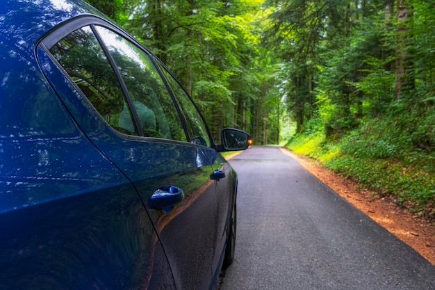 Blue Car on asphalt road on summer day at park Freedom travel concept Summer weekend