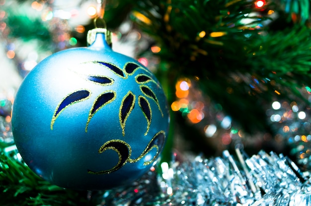 Blue christmas ball on a spruce branch