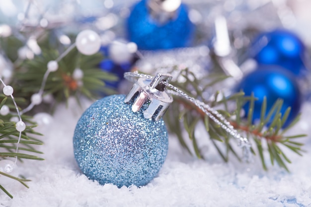 Blue christmas balls on snow