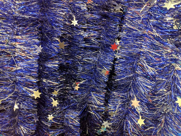 Blue Christmas tinsel. Multi-colored decorations for the celebration of the new year. Texture.