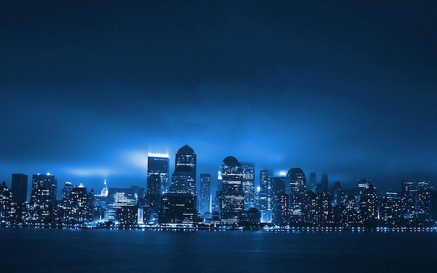 A blue cityscape with a city in the background