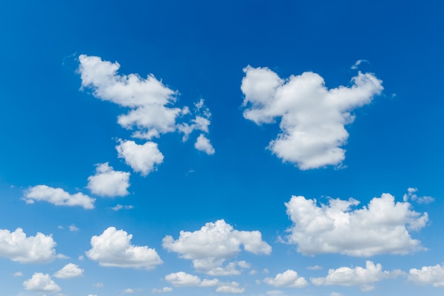 Blue clear sky with white fluffy clouds natural background