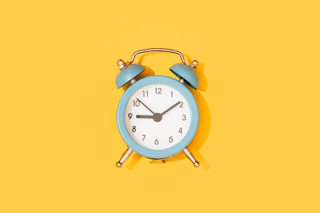 Blue clock on a yellow background