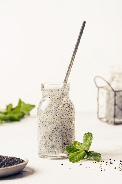 Photo blue cocktail with basil seeds and tropical juice in glass on light background healthy detox beverage for lose weight