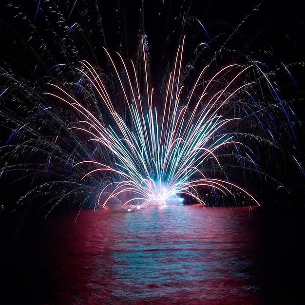 Blue colorful fireworks on the black sky background. Holiday celebration.