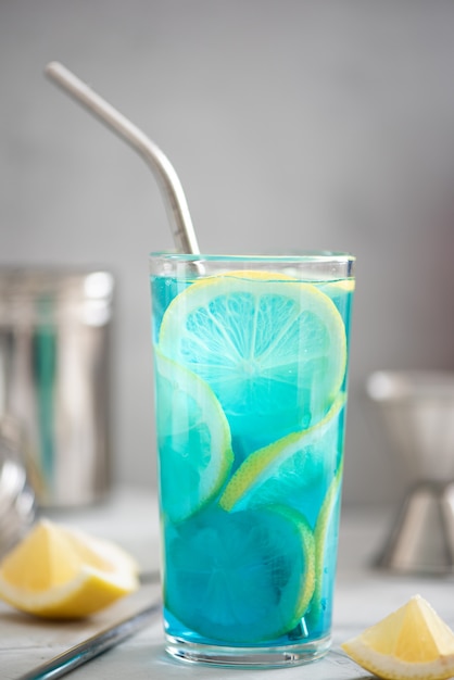 Blue curacao cocktail with lemon slices in tall glasses