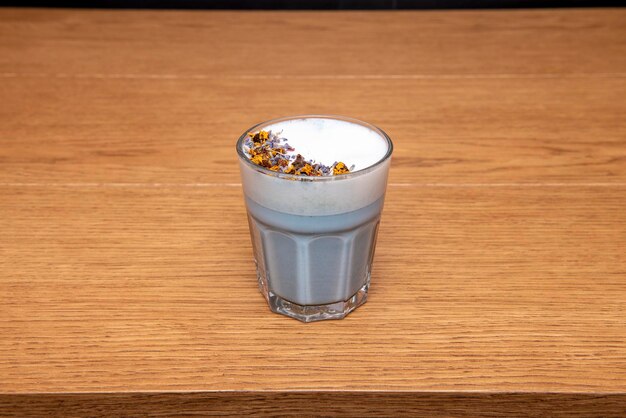 Blue detox drink with cream and dried flowers