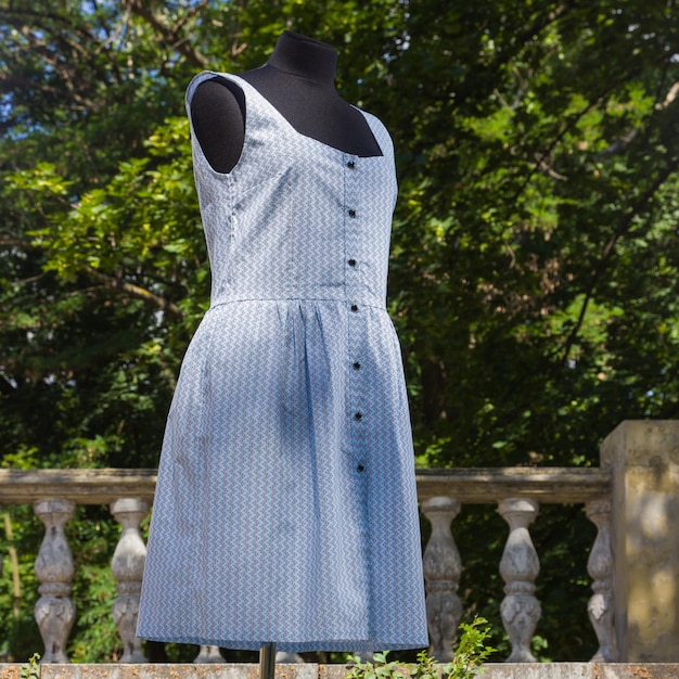 Blue dress on mannequin Summer sarafan on steps of old palace Women's handmade clothes Women's dress to order Copy space