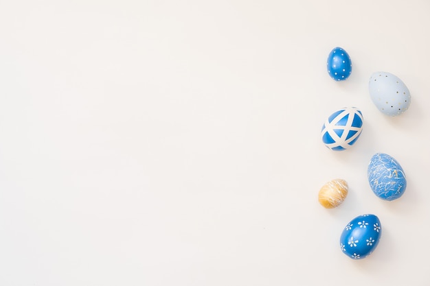 Blue Easter decorated eggs isolated on white surface.