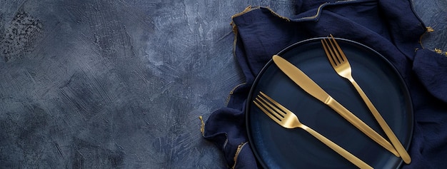 Blue Elegant Table Setting Blue Plates With Gold Cutlery Set Above on Dark Blue Background