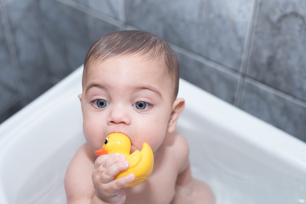 Blue-eyed boy bathing in bathtub