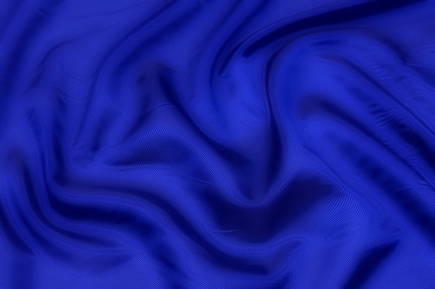 Blue fabric texture background, wavy fabric soft blue color, luxury satin or silk cloth texture.