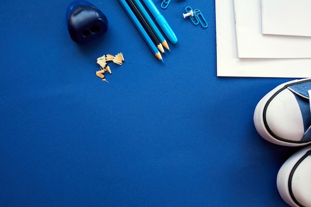 Blue Flat lay Back to school concept, School and office supplies on with copy space. Lots of different stationery items on colorful background