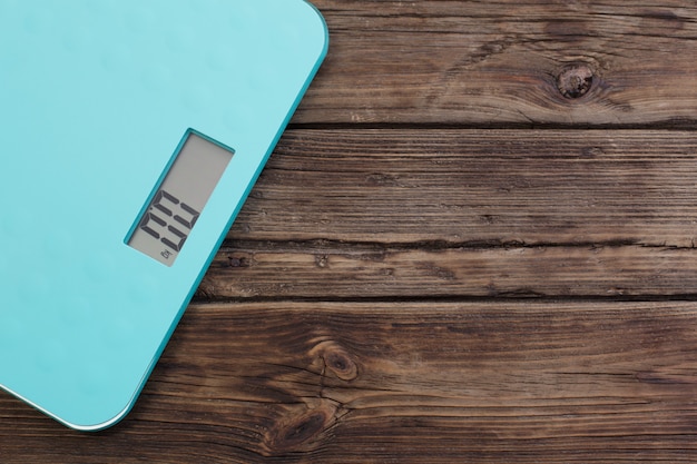 Blue floor scales  on dark wooden table