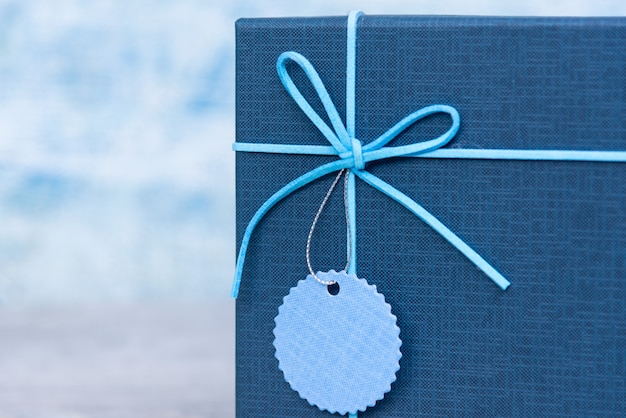 Blue gift box on blue table with copy space