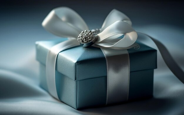 A blue gift box with a white ribbon and a bow on it.