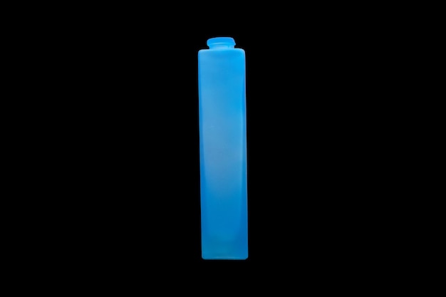 Blue glass bottle isolated on a black background High quality photo