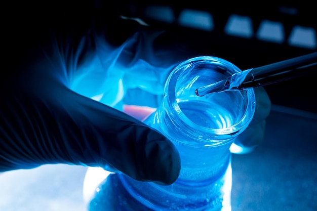 blue glass test tube,Asian female scientist with test tubes doing research in clinical laboratories