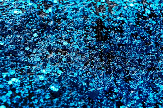 Blue glitter makeup product background Eye shadow lip gloss and face for holiday makeup backdrop selective focus