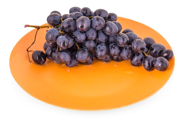 Blue grapes in a clay plate