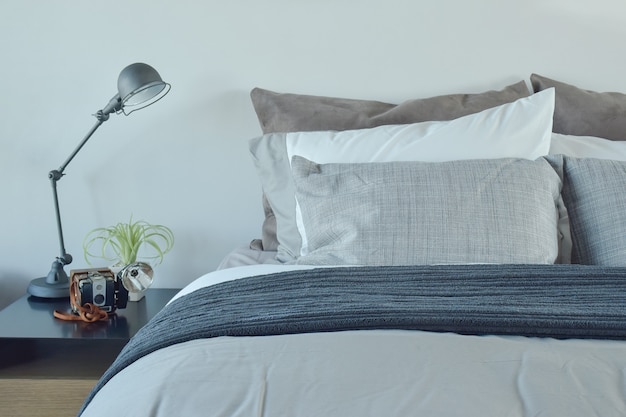 Blue and gray color scheme bedding with industrial style table lamp