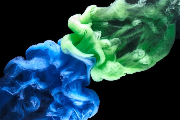 Blue green smoke on black ink background, colorful fog, abstract swirling ocean sea, acrylic paint pigment underwater