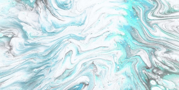 A blue and green swirly marbled surface with a white swirl.