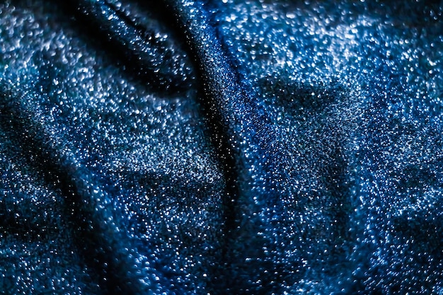 Blue holiday sparkling glitter abstract background luxury shiny fabric material for glamour design and festive invitation