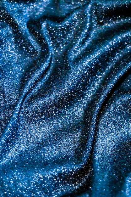 Blue holiday sparkling glitter abstract background luxury shiny fabric material for glamour design and festive invitation