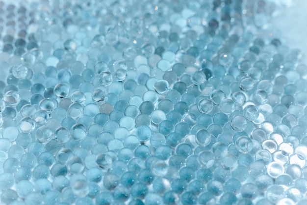 Photo blue hydrogel balls or aqua crystal jelly soil for flower or plant or home background