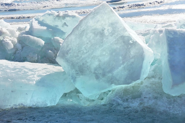 Blue ice clear transparent hummocks on the frozen lake