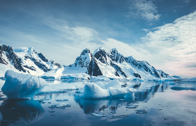 Blue ice covered mountains in south polar ocean winter antarctic landscape the mounts reflection in